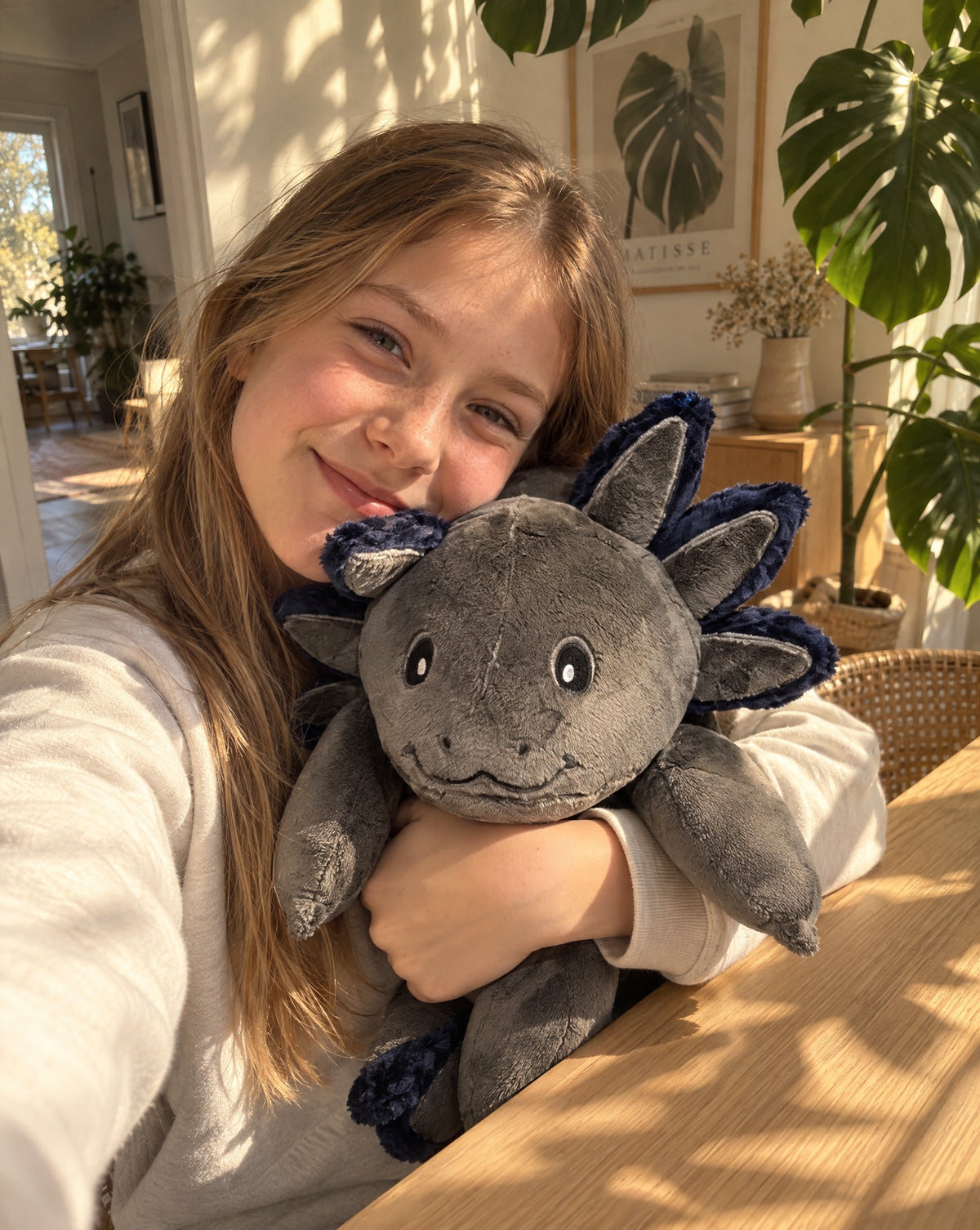 Child hugging the weighted Axolotl in Blue Flame, 2.3 kg