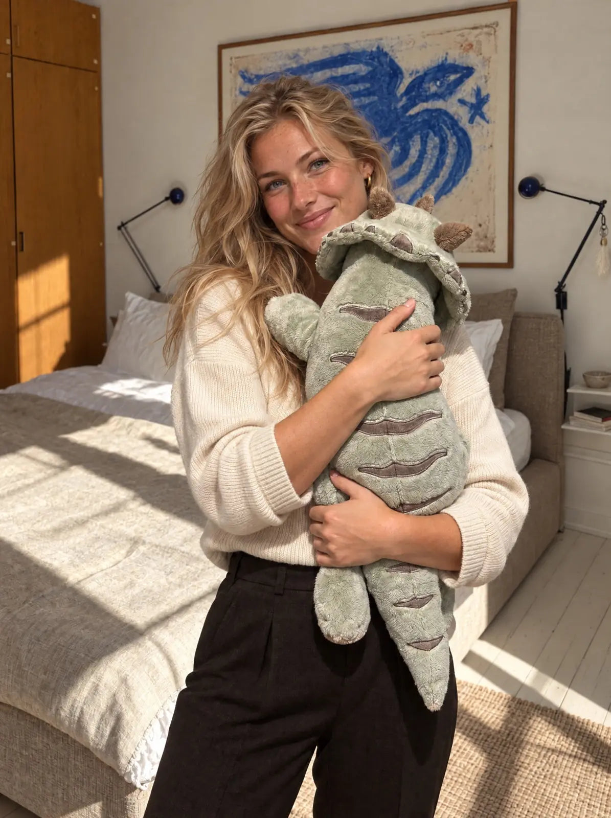 Woman hugging the weighted Dinosaur in Matcha, 2.3 kg, in her bedroom