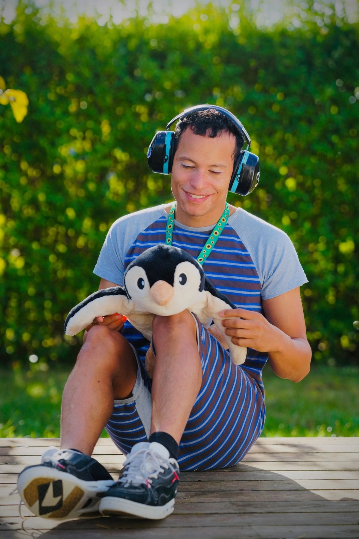 Martin Moxness smiling with the penguin on his knees