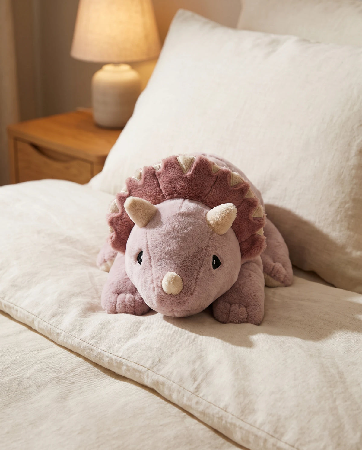 Weighted Dinosaur in Wild Rose lying on a bed #Colour_Wild Rose