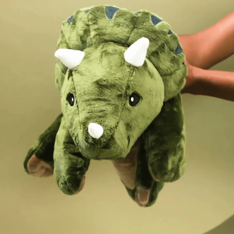 person holding and shaking weighted dinosaur plush from brease