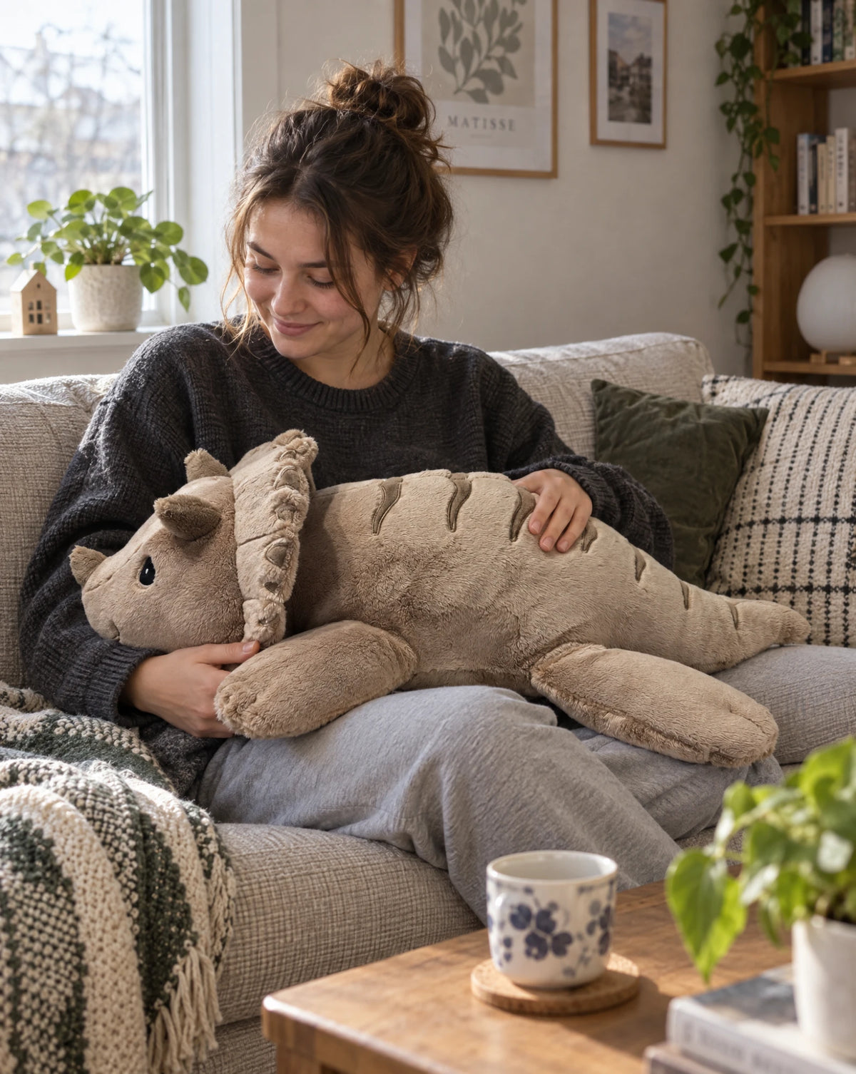 Woman on the sofa with the weighted Dinosaur in Mushroom on her lap #Colour_Mushroom